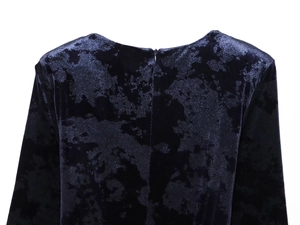 Detail of dark blue velvet dress showing V-neckline and hidden zipper closure on the back