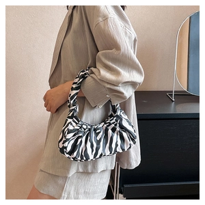 Detailed view of black and white zebra print cloud bag with pleated handle detail
