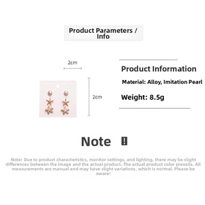 Detailed view of starfish stud earrings set with faux pearls and gold alloy finish