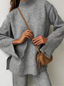 Women's turtleneck knit sweater in grey featuring ribbed texture and split cuffs design