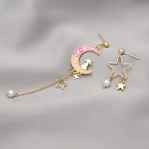 Detail of asymmetrical cat moon and star earrings with colorful gradient tassels and pearls