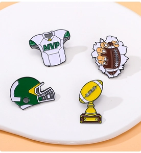 Detailed view of four American football enamel pins featuring MVP jersey and helmet