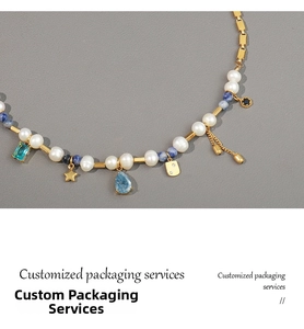 Detail of vintage French necklace with freshwater pearls and blue gemstone charms