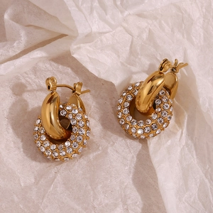 Close-up of 18K gold plated hoop earrings featuring micro-pave crystals on paper