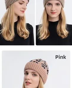 Detail showing soft leopard print knit fabric and solid beige winter beanie textures