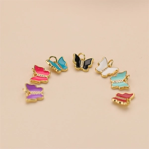 Close-up of colorful butterfly charms with gold frames and sparkling zircon settings