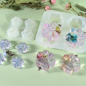 Detail view of cat paw silicone molds with iridescent resin crafts and dried flowers decor