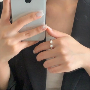 Mirror selfie showing a 925 sterling silver adjustable ring with a white pearl detail