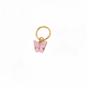 Detailed view of a pink resin butterfly charm with golden ring for DIY hair braiding