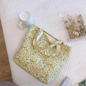 Handheld floral cotton canvas tote bag with yellow flower patterns and zipper closure