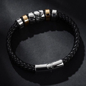 Men's punk braided leather bracelet featuring silver cross bead on a dark textured background
