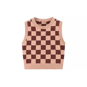 Détail d'un gilet en tricot à damier rose et marron avec col rond et coupe sans manches