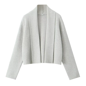 Detailed view of light grey knit cardigan texture and white size label showing S