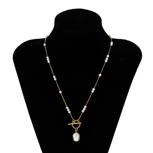 Detail view of baroque pearl pendant necklace with gold chain and T-bar toggle clasp