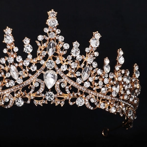 Macro side view of luxury gold bridal crown featuring teardrop crystals and brilliant rhinestones