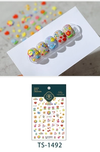 Macro detail of 3D embossed nail art stickers featuring colorful spring cartoon patterns