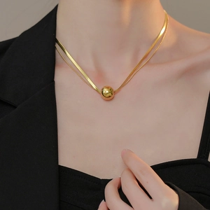 Double layered gold titanium necklace featuring a snake chain and a sleek bead ball pendant