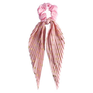 Detail of pink satin scrunchie with long pleated ribbon featuring golden cross patterns