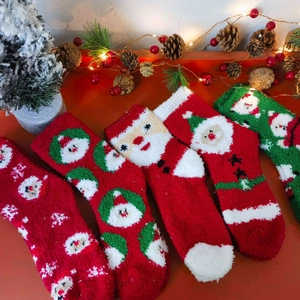 Christmas coral fleece socks with festive reindeer and snowflake patterns in red and green