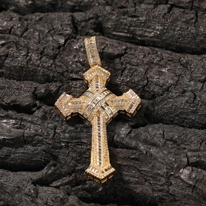Macro detail of gold cross pendant with rectangular and round cubic zirconia stones
