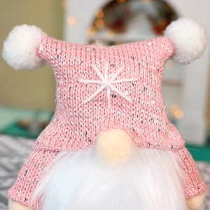Pink knitted Christmas gnome with sequins and warm white glowing lights for holiday decor