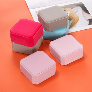 Detailed view of colorful velvet octagonal jewelry boxes in red pink blue and grey