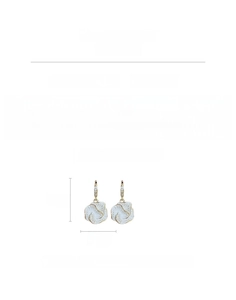 Detailed macro view showing a 6.2g gold plated flower earring with zircon and copper texture