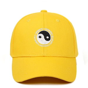 Detail of embroidered Tai Chi emblem and Swimming text on yellow cotton baseball cap