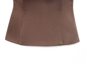 Detailed view of deep brown fabric with precise stitching and curved hemline