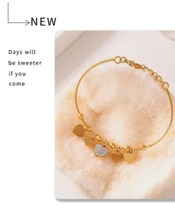 Detailed macro view of 18k gold plated bracelet with sparkling heart charms and diamonds
