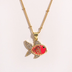Detailed close-up of a golden fish pendant with red enamel and sparkling rhinestones