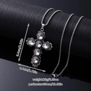 Detail shot showing a silver cross pendant with dimensions and weight measurements