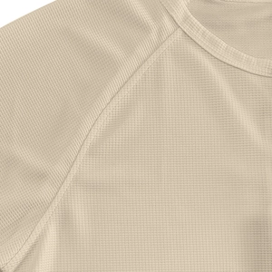 Macro shot of waffle knit texture and seam detail on men's beige Henley shirt