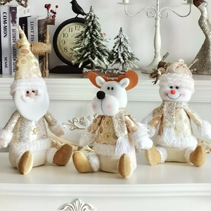 Detail of plush gold and white Christmas figurines including Santa, elk, and snowman