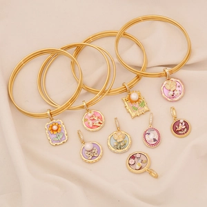 French vintage gold bracelets with colorful enamel charms and sunflower butterfly designs