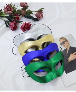 Detailed view of shimmering gold, silver, blue and green metallic masquerade eye masks