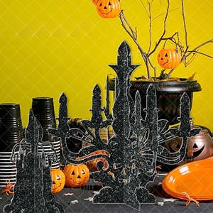 Macro detail of Halloween candle silhouette with black glitter finish and bat elements