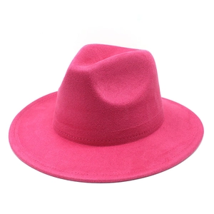 Close-up of a rose red faux suede fedora with teardrop crown and fine stitching details