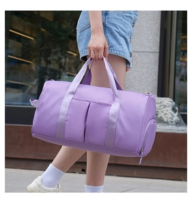 Close-up of purple travel duffel bag with durable handles and side compartment pocket