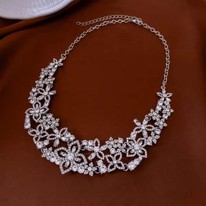 Exquisite floral necklace with sparkling rhinestones on an elegant dark silk background