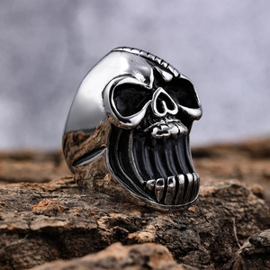 3D screaming skull ring in punk style with vintage silver finish on natural bark base