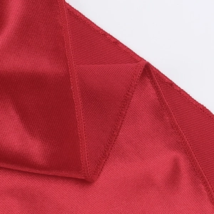 Detail of red high-elastic bandage fabric with professional knit texture and stitching