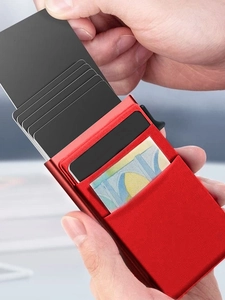 Red RFID blocking metal card holder showing automatic pop-up function for credit cards
