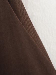 Macro view of dark brown twill fabric texture with high density weaving detail