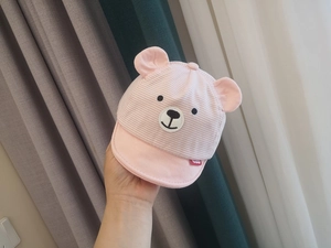 Detail of pink striped baby sun hat featuring 3D bear ears and soft cotton brim