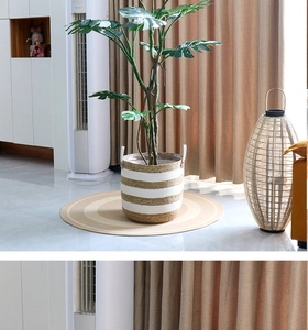 Detail of woven rattan plant basket with white stripes and convenient dual handles