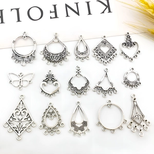 Macro shot of various silver alloy jewelry pendants for DIY earrings crafting