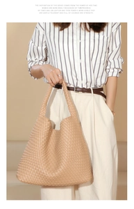 Detail of khaki hand-woven PU leather tote bag with smooth texture and sturdy shoulder strap