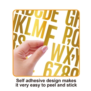 Close-up of peeling gold self-adhesive alphabet sticker showing easy-to-use feature