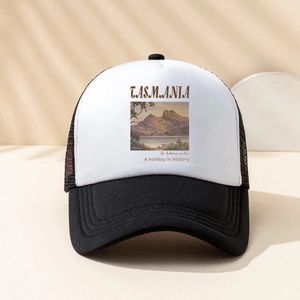 Detail of a black and white trucker hat featuring Tasmania holiday airline printing